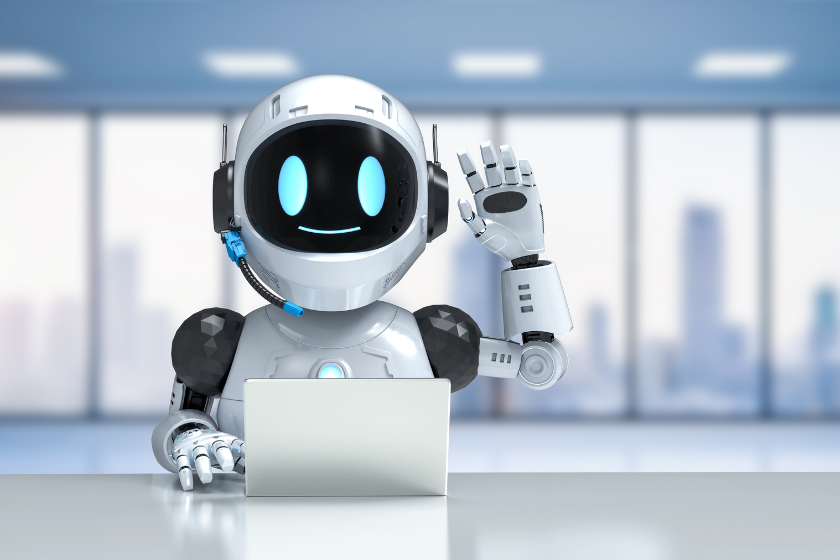Freundlicher KI Roboter sitzt mit Laptop im Büro und winkt in die Kamera. Das Bild symbolisiert ChatGPT und künstliche Intelligenz im Alltag.