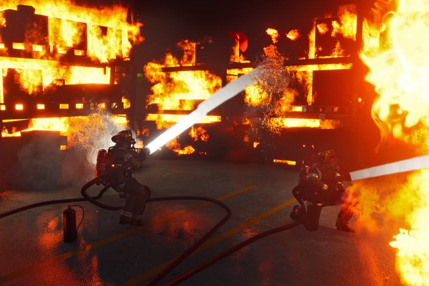 Firefighting Simulator – The Squad mit Feuerwehrleuten beim Löschen eines großen Lagerhallenbrands.