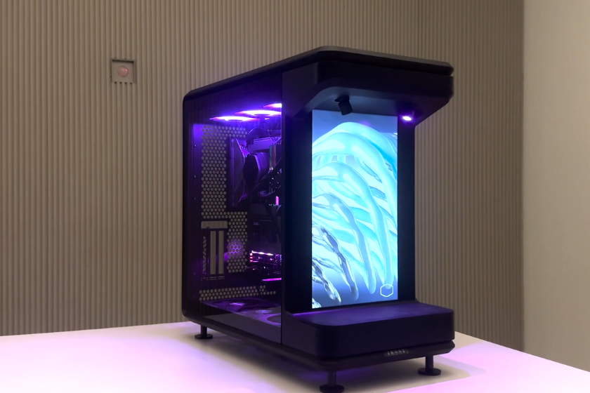 Cooler Master MasterFrame 360 Stage LCD mit integriertem vertikalem LCD-Display, RGB-Beleuchtung und Tempered-Glass-Seitenteil auf einem weißen Tisch.