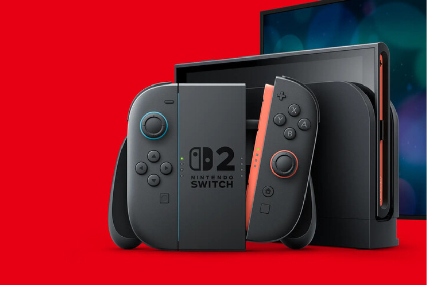 Nintendo Switch 2 mit schwarzen Joy-Cons und Dockingstation vor rotem Hintergrund. Die Handheld-Konsole ist zusammen mit einem Bildschirm in einer Produktdarstellung zu sehen