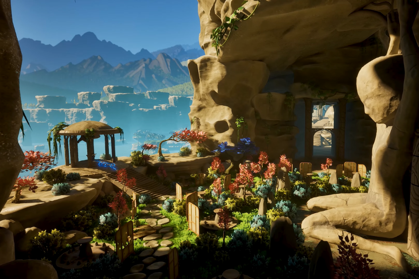 Screenshot aus Honeycomb: The World Beyond: Eine farbenfrohe Landschaft mit üppiger Vegetation, blühenden Pflanzen und verwinkelten Steinpfaden erstreckt sich zwischen imposanten Felsformationen. Im Hintergrund sind Berge und eine weitläufige Küstenlandschaft zu sehen, während die Szene von warmem Sonnenlicht beleuchtet wird.