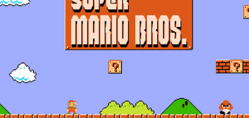 Screenshot des NES-Klassikers Super Mario Bros. mit dem Titelbildschirm des Spiels. Zu sehen sind die typische Pixelgrafik, Mario auf einer Plattform, ein Goomba-Gegner, grüne Hügel, Wolken sowie die ikonischen Fragezeichen-Blöcke vor blauem Hintergrund.