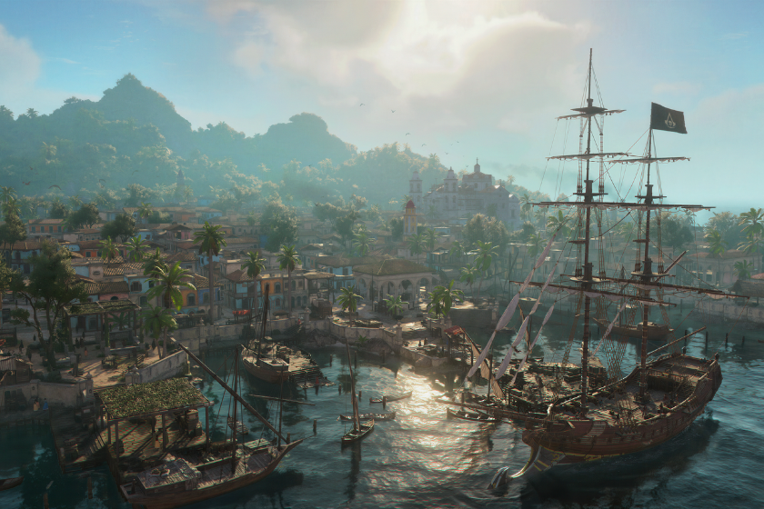 Das Bild zeigt eine weitläufige Hafenstadt aus dem Spiel Assassin’s Creed Black Flag Resynced mit historischen Segelschiffen, die in einer sonnigen Bucht vor Anker liegen. Im Hintergrund erstrecken sich dicht bewachsene Hügel sowie koloniale Gebäude und eine Kirche, während das Sonnenlicht die Wasseroberfläche glitzern lässt und eine karibische Piratenatmosphäre erzeugt. Das Motiv dient als Titelbild zum Artikel „Gaming-Highlights im Juli 2026“ und verweist auf die wichtigsten Spiele-Neuerscheinungen und Gaming-Highlights des Monats.