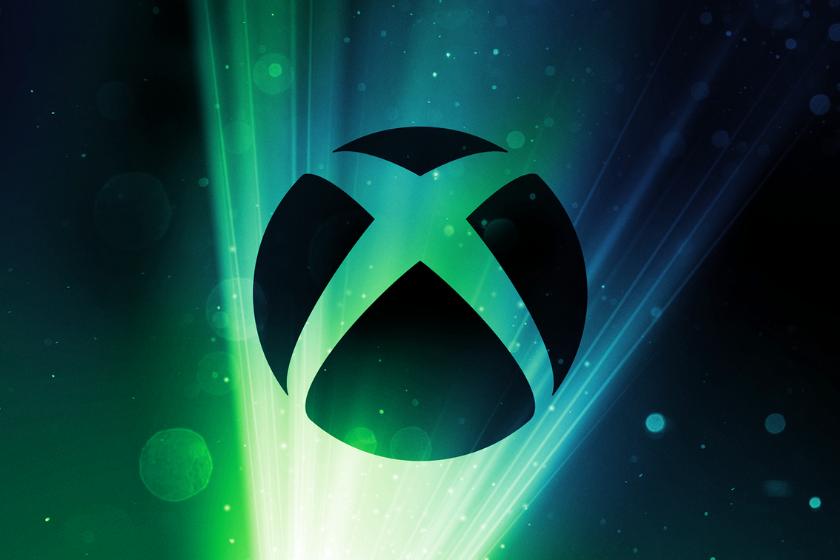 Xbox-Logo vor grün-blau leuchtendem Hintergrund mit Lichtstrahlen.
