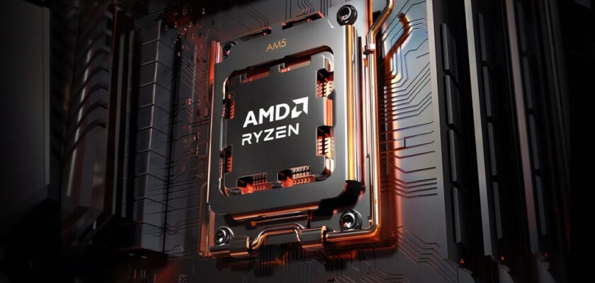 Nahaufnahme eines AMD-Ryzen-Prozessors mit AM5-Sockel, dessen Metallgehäuse mit dem weißen Logo und Schriftzug beschriftet ist. Um den CPU-Sockel schlängeln sich glänzende, kupferfarben schimmernde Kühlrohre, während im Hintergrund die dunklen Leiterbahnen und Strukturen einer Hauptplatine erkennbar sind.
