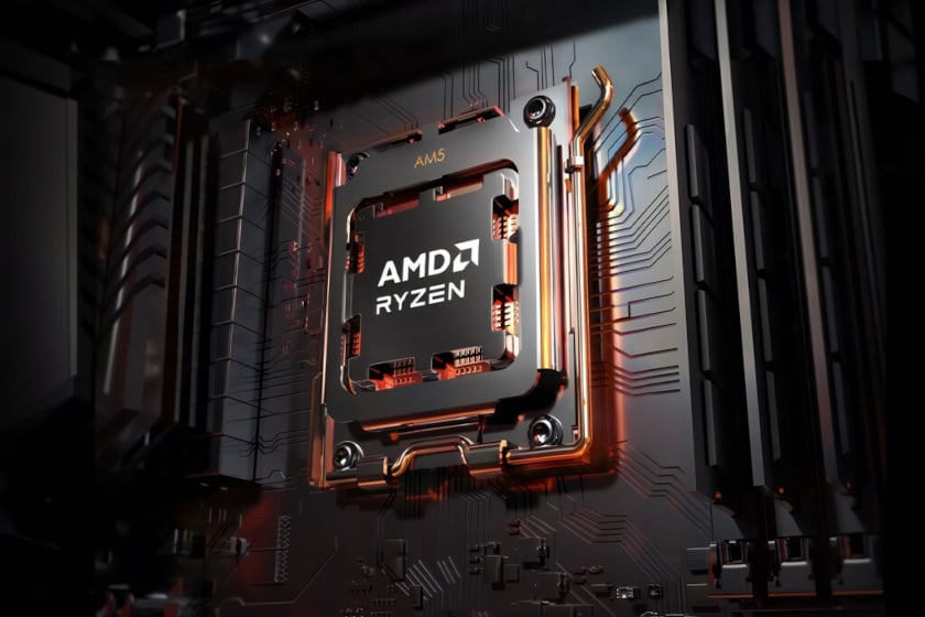 Nahaufnahme eines AMD-Ryzen-Prozessors mit AM5-Sockel, dessen Metallgehäuse mit dem weißen Logo und Schriftzug beschriftet ist. Um den CPU-Sockel schlängeln sich glänzende, kupferfarben schimmernde Kühlrohre, während im Hintergrund die dunklen Leiterbahnen und Strukturen einer Hauptplatine erkennbar sind.
