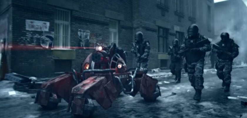 Screenshot aus dem Videospiel „Tom Clancy's Ghost Recon: Future Soldier" zeigt vier schwer bewaffnete Soldaten in taktischer Ausrüstung, die durch eine verschneite, zerstörte Stadtstraße vorrücken. Neben ihnen bewegt sich ein bewaffneter, rot leuchtender Militärroboter mit mehreren Beinen, während im Hintergrund heruntergekommene Häuserfassaden und aufsteigender Rauch die düstere Kriegsatmosphäre unterstreichen.