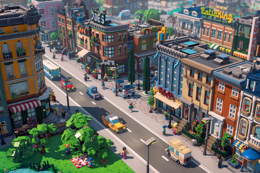 3D-Renderbild zeigt eine detailreiche LEGO-Stadtszene aus dem Videospiel „LEGO Skylines“ mit mehrstöckigen Gebäuden, Geschäften und beschrifteten Ladenschildern entlang einer Straße. Auf der Straße fahren verschiedene LEGO-Fahrzeuge, während zahlreiche LEGO-Figuren auf Gehwegen und in einem kleinen Park mit Bäumen unterwegs sind.