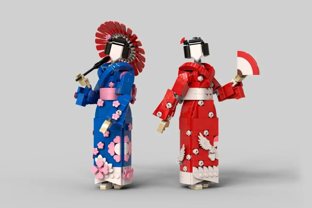 Das Bild zeigt zwei Figuren aus LEGO-Steinen im Stil traditioneller japanischer Geishas. Die Modelle tragen detailreiche Kimonos in Blau und Rot und halten einen Fächer beziehungsweise eine Pfeife in den Händen.
