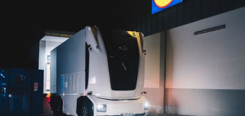Kabinenloser autonomer Elektro-Lkw von Einride bei einer nächtlichen Fahrt auf einem Betriebsgelände.