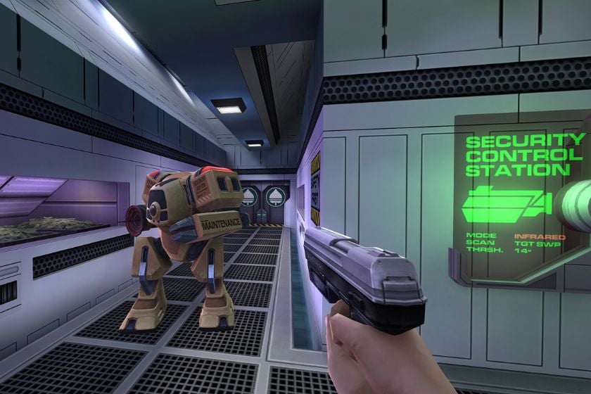 Spielszene aus System Shock 2: 25th Anniversary Remaster mit einer Waffe und einem Roboter in einem futuristischen Raumschiff-Korridor.